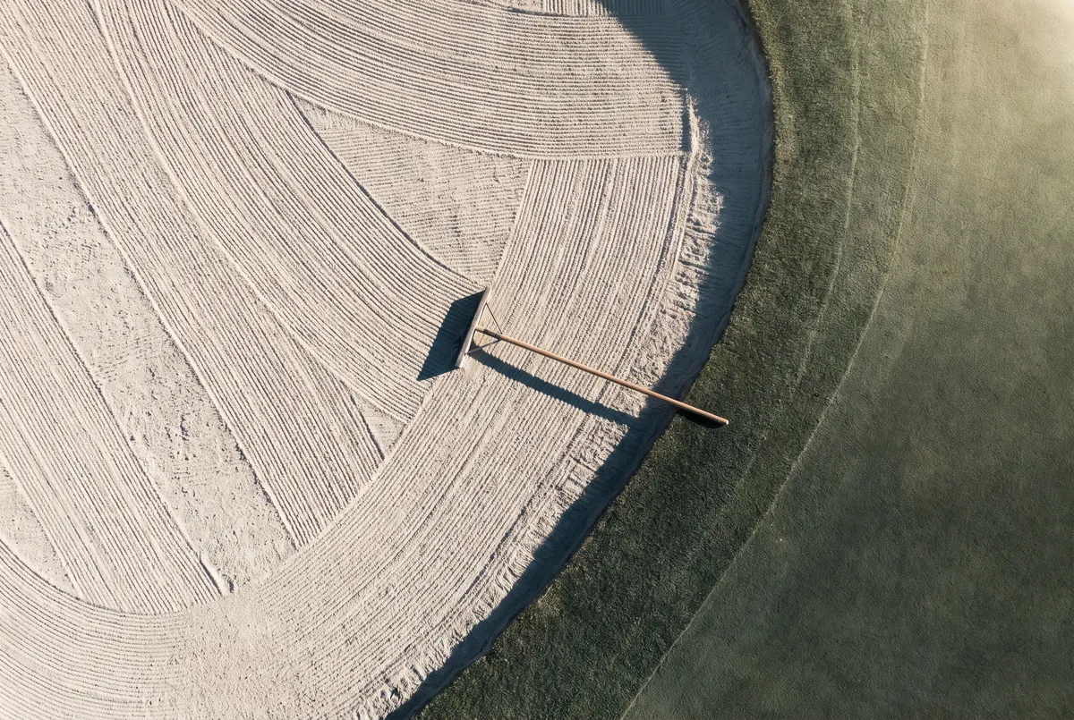 Freshly raked lines in a bunker, seen from above.